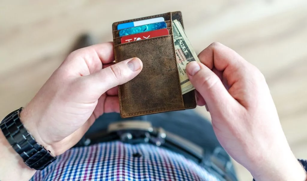 Man getting money from his wallet